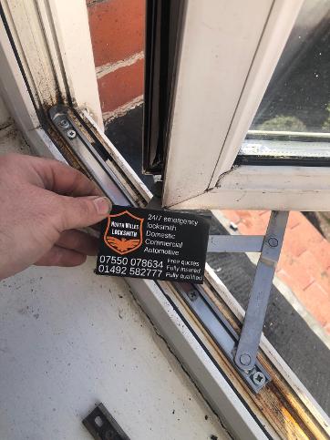 Window hinge repair by North Wales Locksmith in the Caernarfon area
