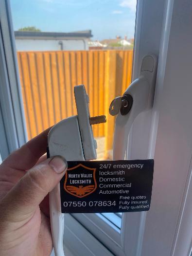 Emergency residential locksmith repairing a uPVC door lock in North Wales